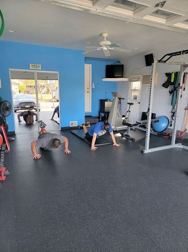 A group of men are doing push ups in a gym.