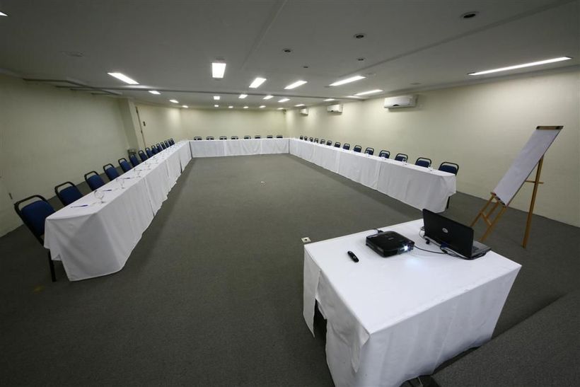 A conference room with long tables and chairs