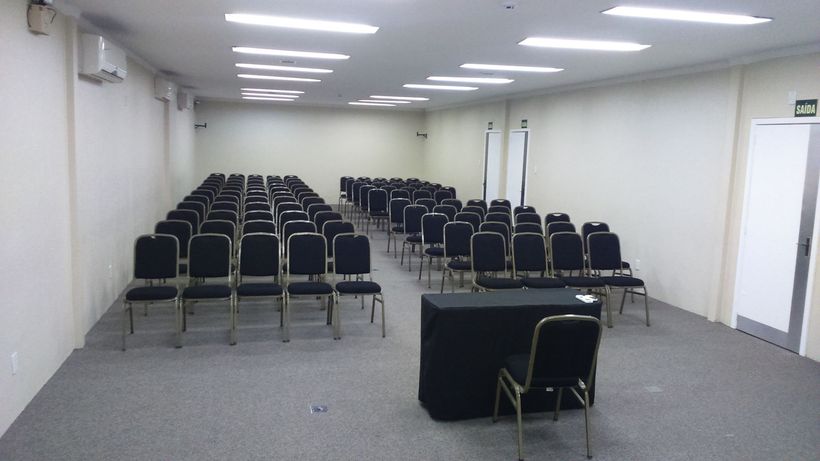 A conference room with rows of chairs and a table