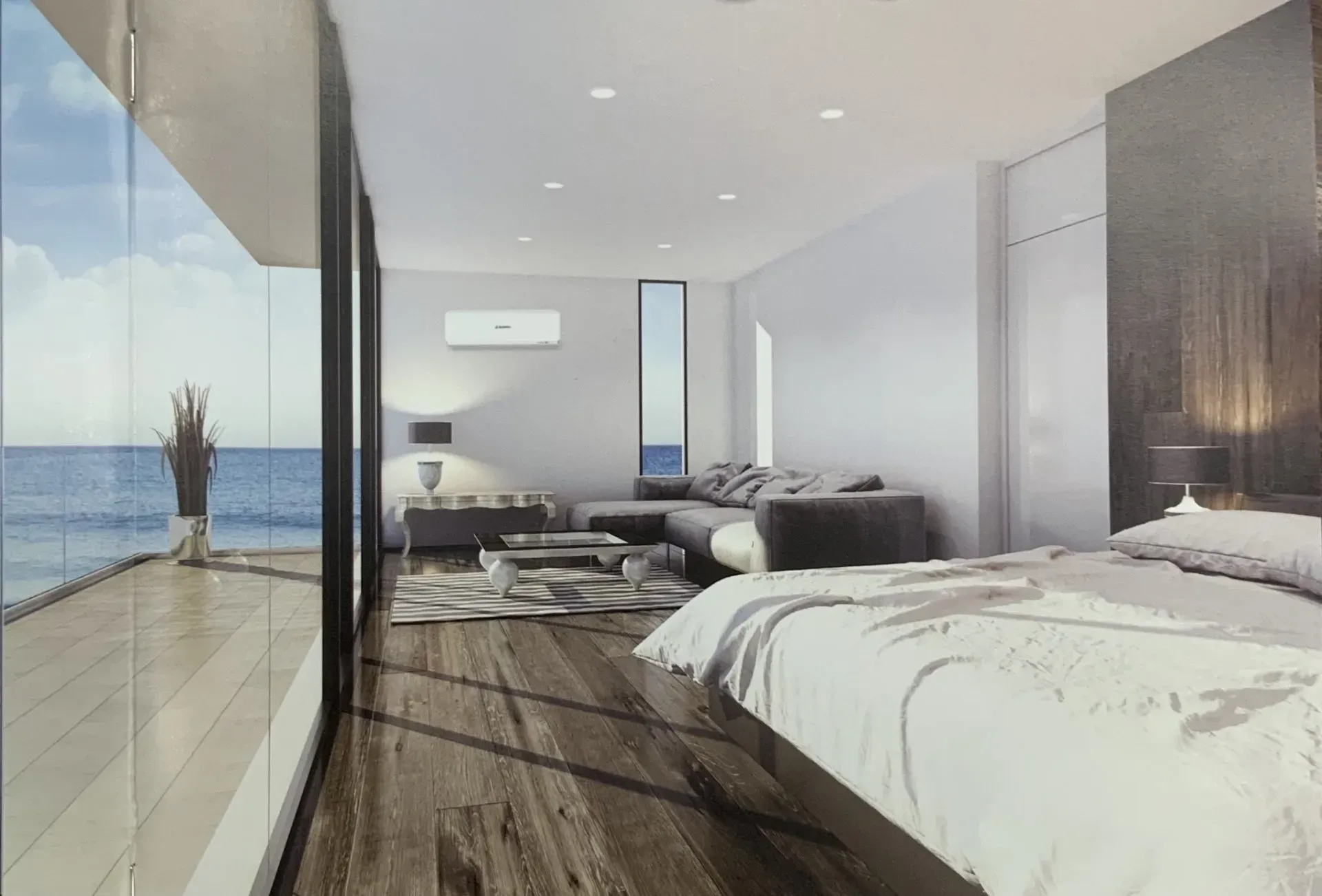 A Bedroom With a Large Bed and a Balcony Overlooking the Ocean — DMC Electrical & Air Cooling Pty Ltd in Townsville City, QLD