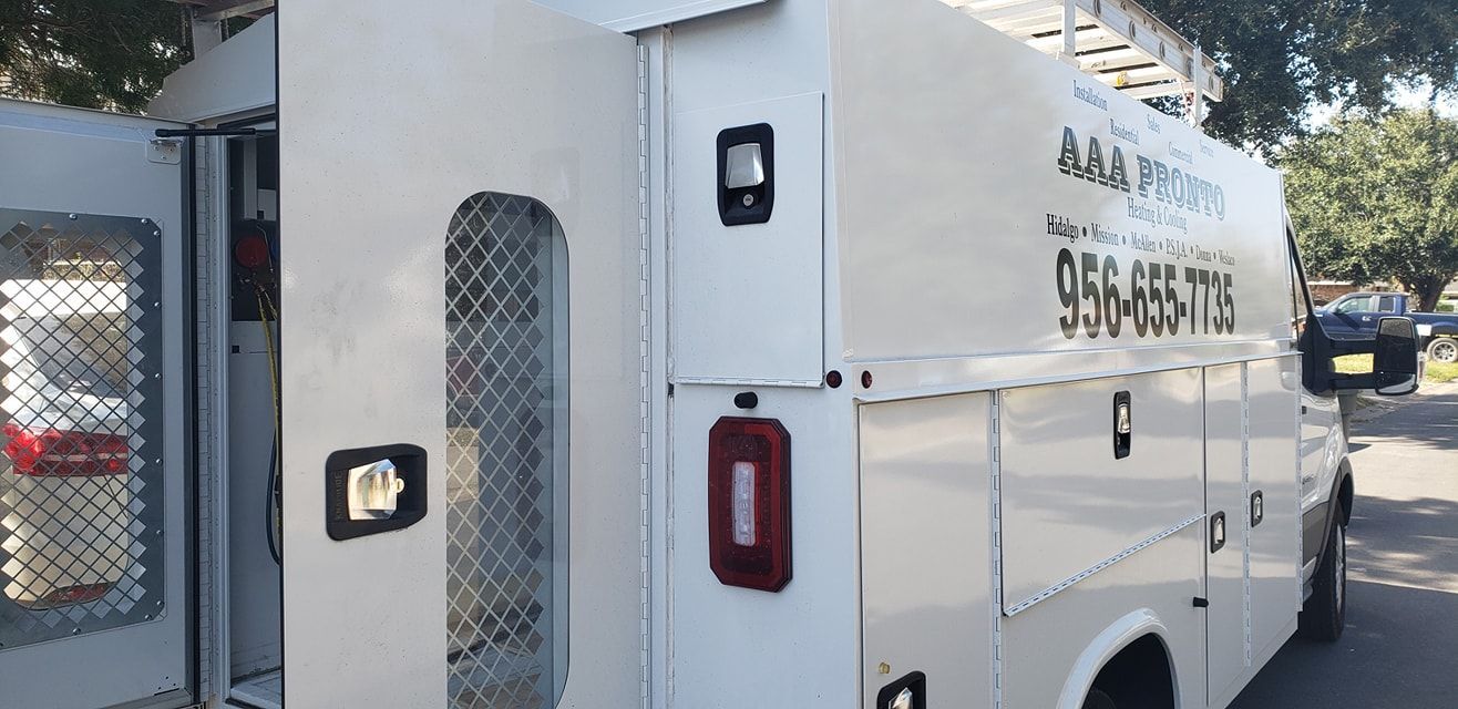 A white ambulance is parked on the side of the road.