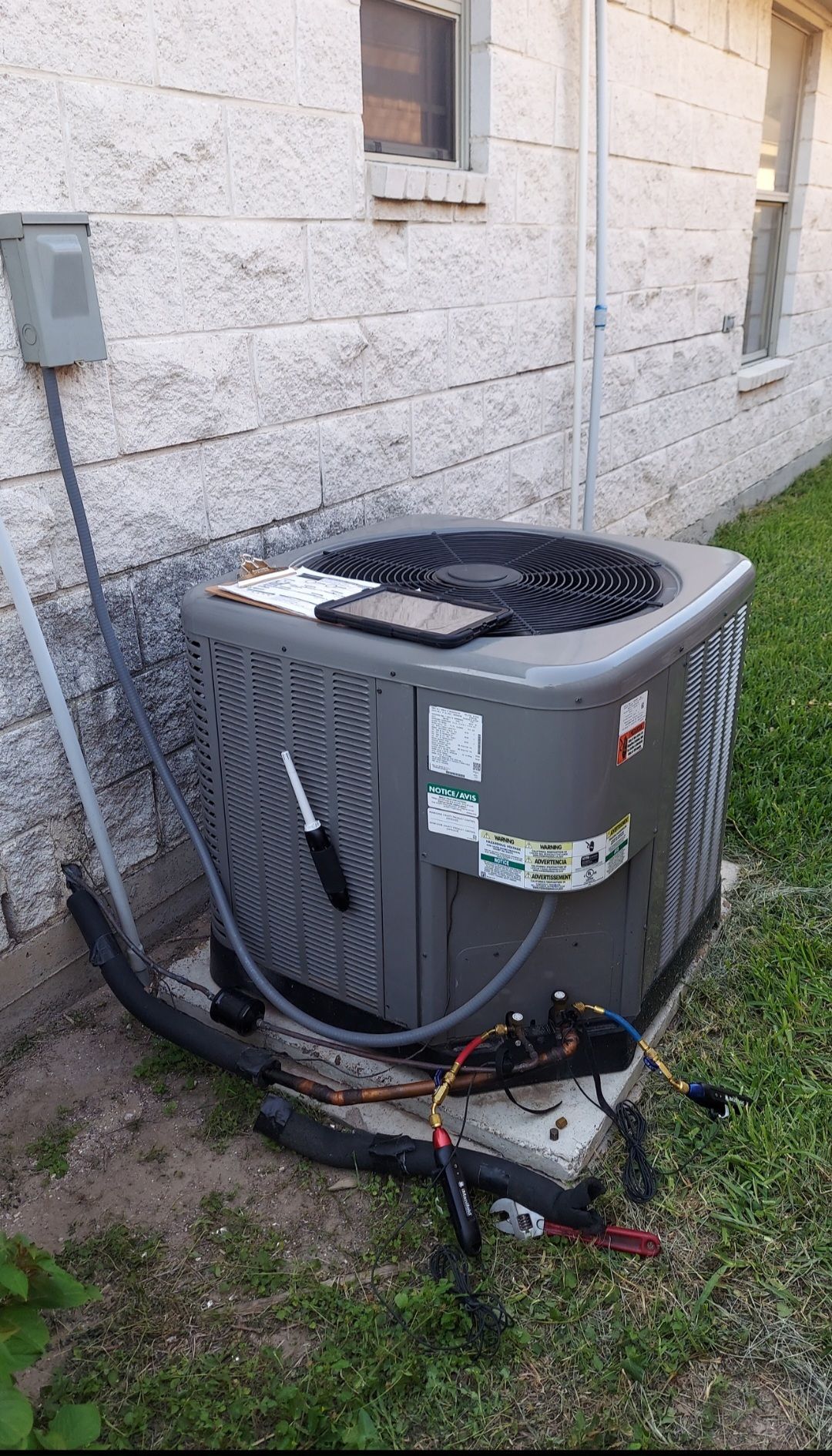 A man is working on an air conditioner in a room.