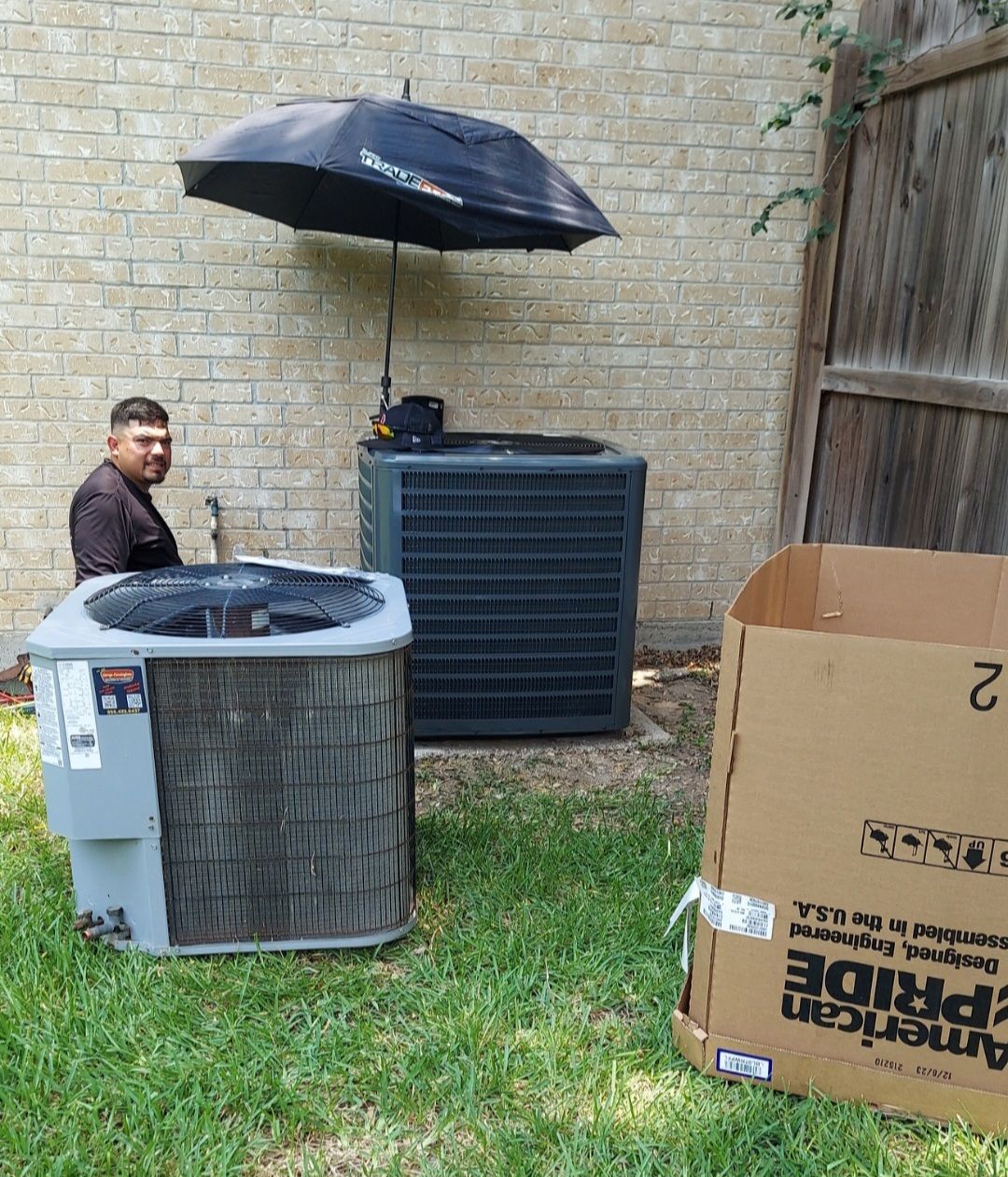 There are a lot of air conditioners on the roof of a building.