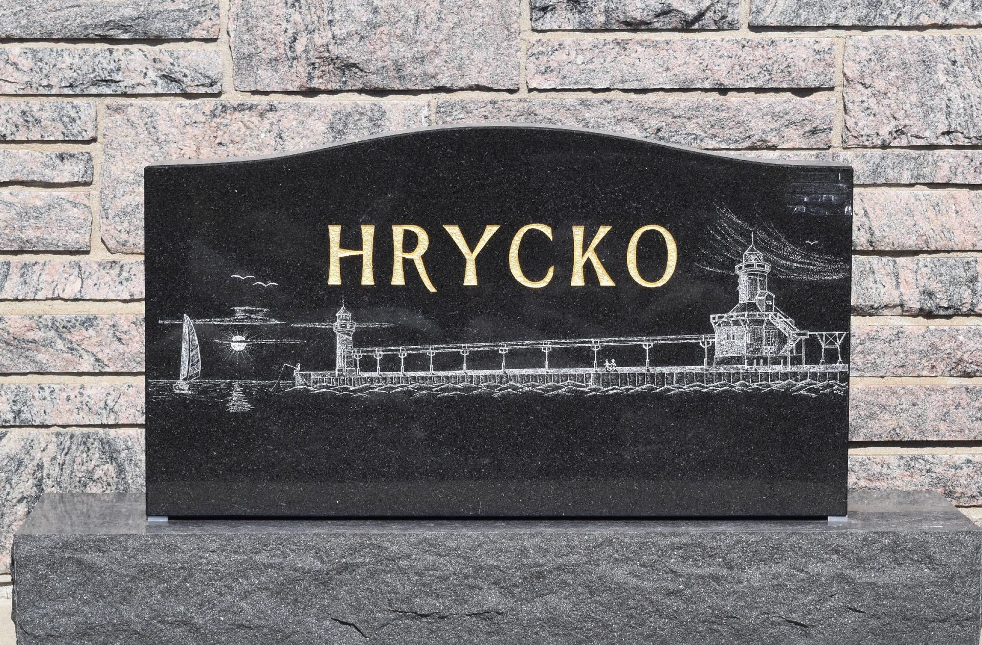 A black gravestone with the name hrycko on it