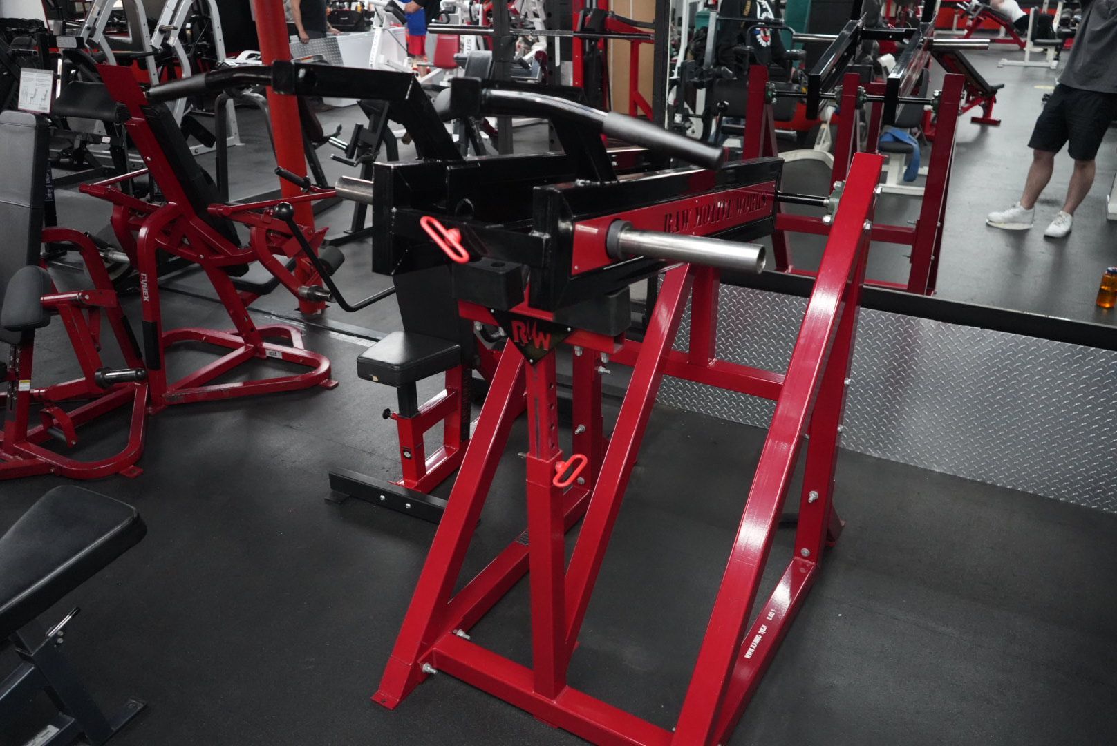 A gym with a lot of red and black equipment