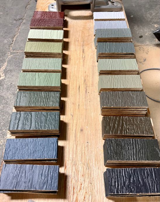 A row of wooden blocks of different colors are lined up on a wooden table.