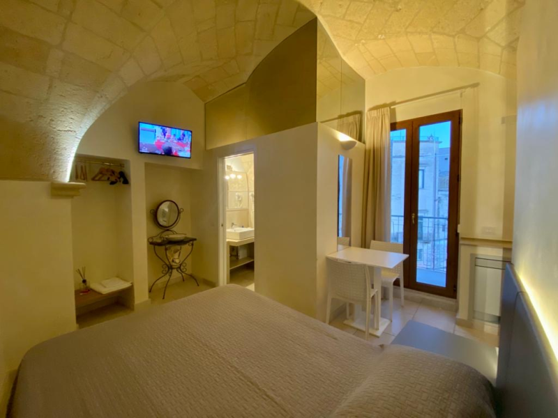 Una camera da letto con un letto grande e una televisione a parete.