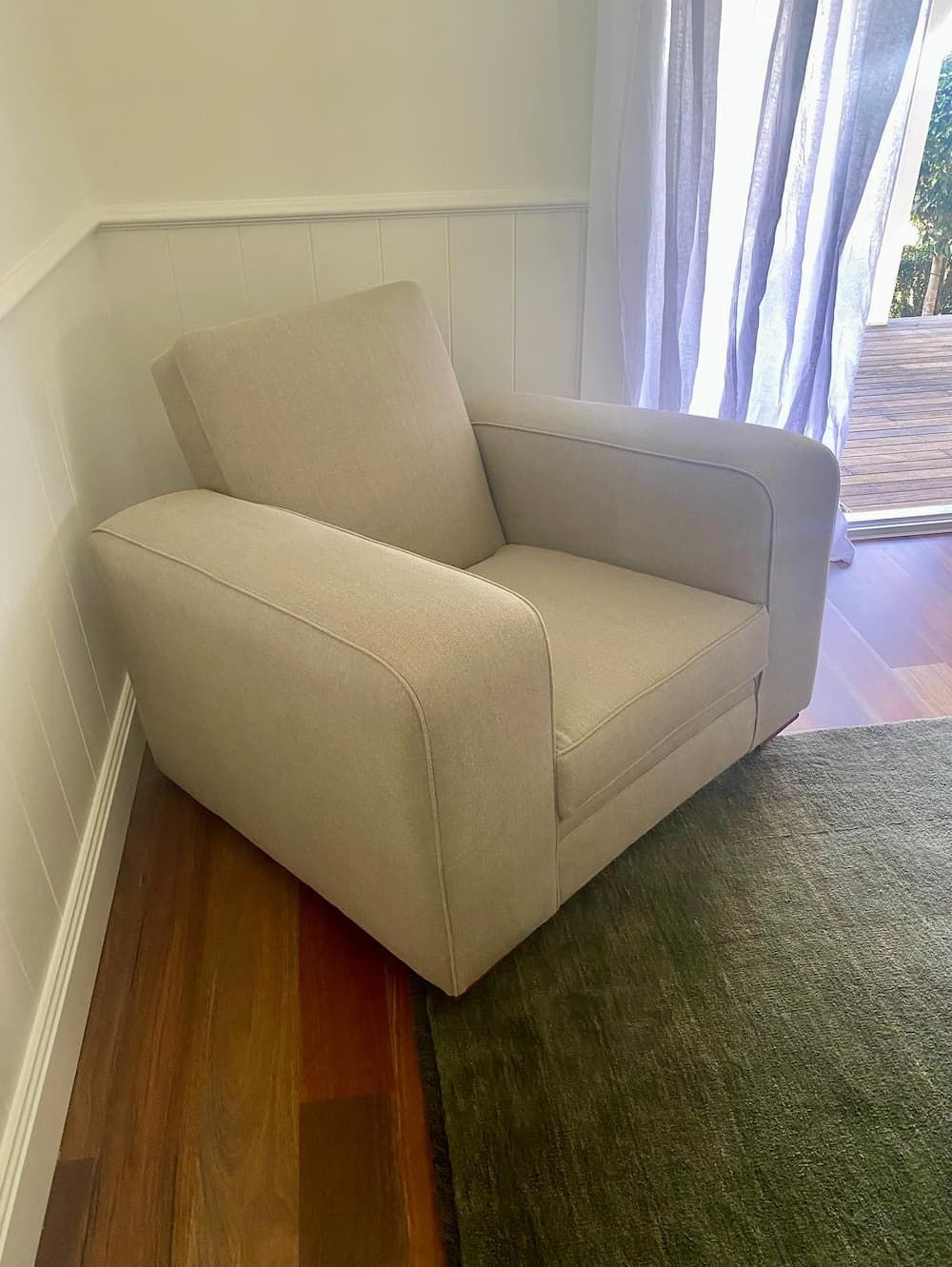 Beige Armchair in A Corner Next to Wood Flooring — Metreson Upholstery In Unanderra, NSW