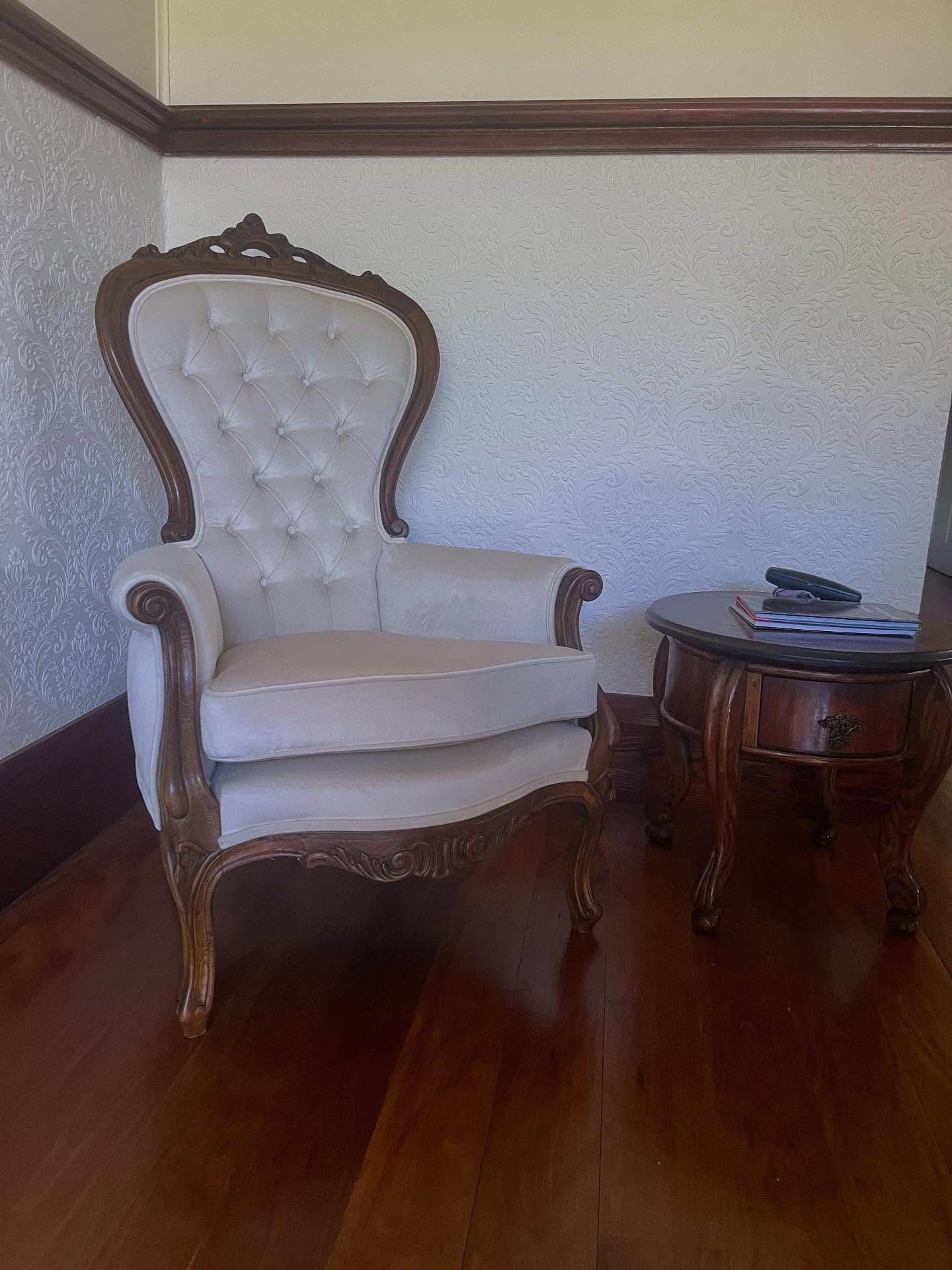 Ornate Ivory Upholstered Armchair Beside a Small Wooden Table — Metreson Upholstery In Unanderra, NSW