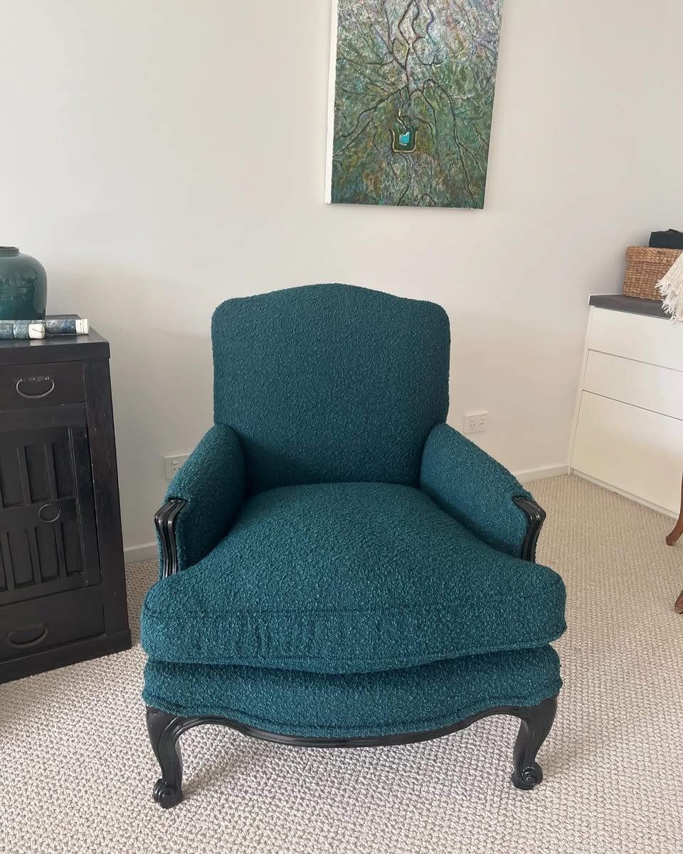Teal upholstered armchair with black trim in a room with neutral walls. — Metreson Upholstery In Unanderra, NSW