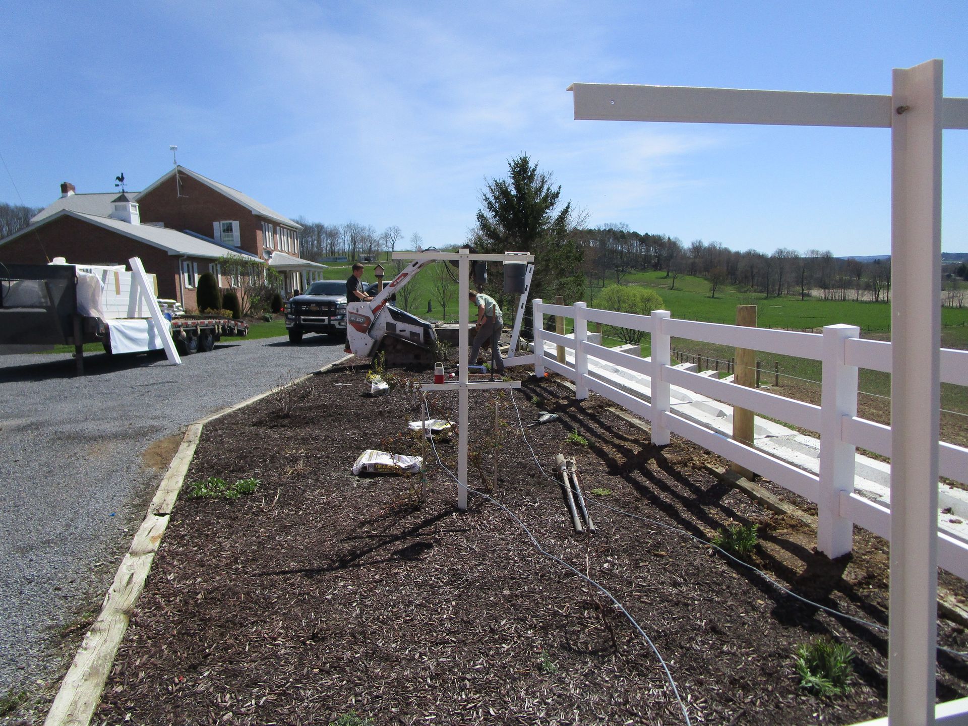 A white fence is being built in front of a house — Somerset, PA — Stoltzfus Fence