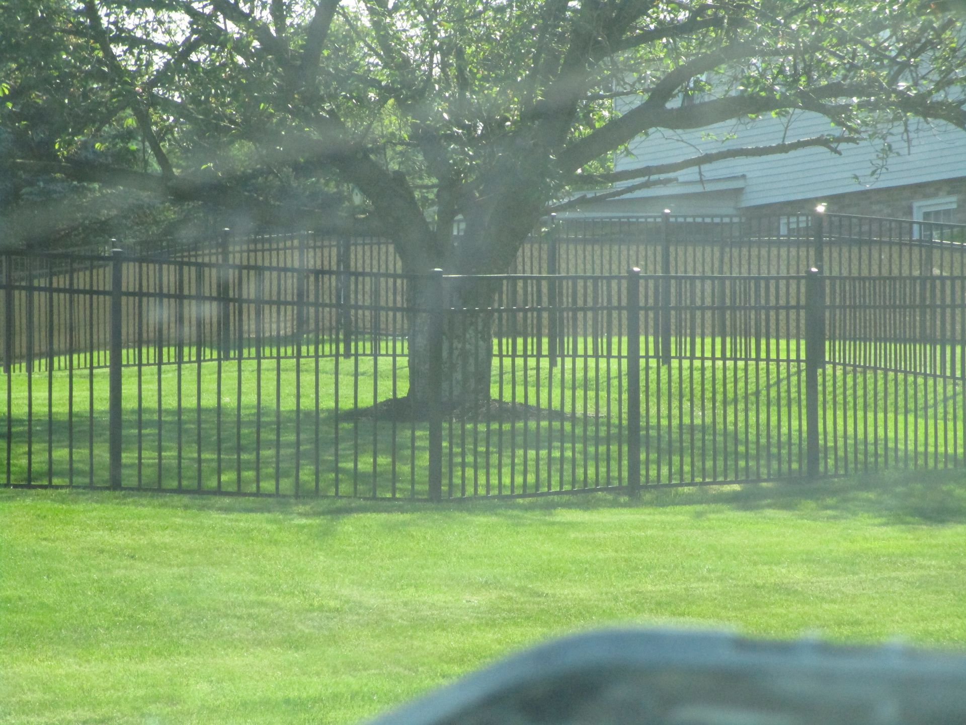 A fence surrounds a lush green — Somerset, PA — Stoltzfus Fence