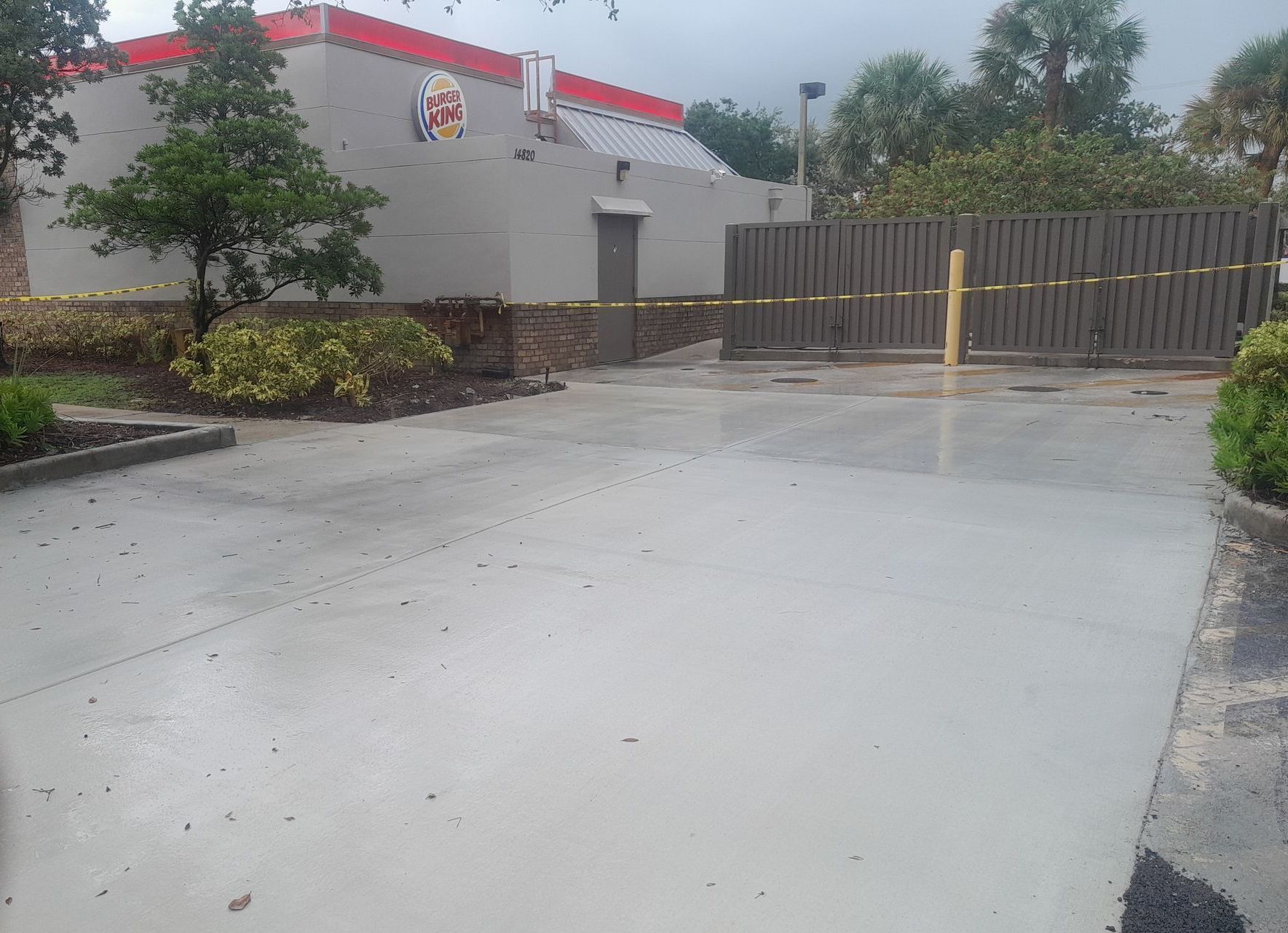 A concrete driveway leading to a burger king restaurant