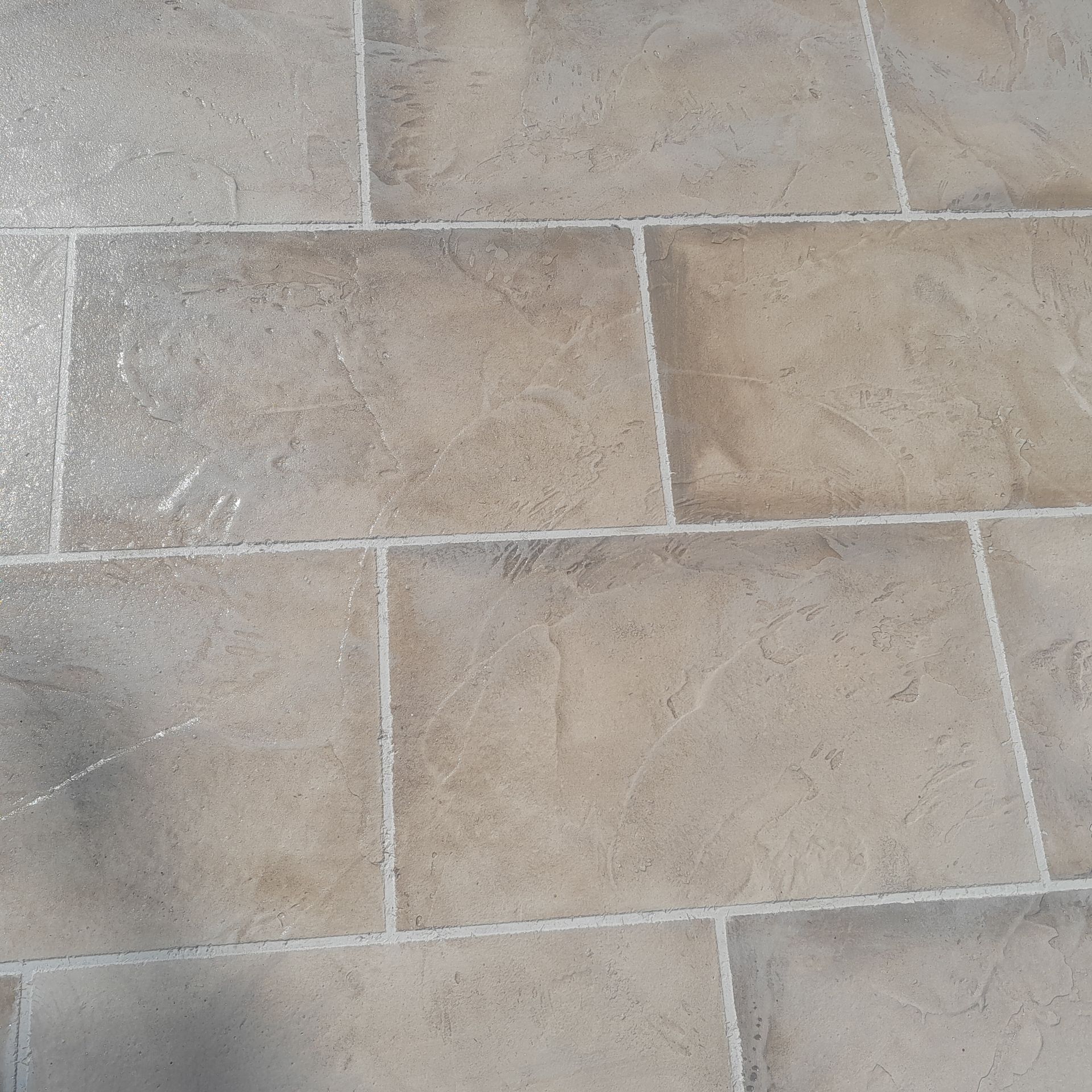 Beige rectangular tiles with white grout on a floor in Parkland FL