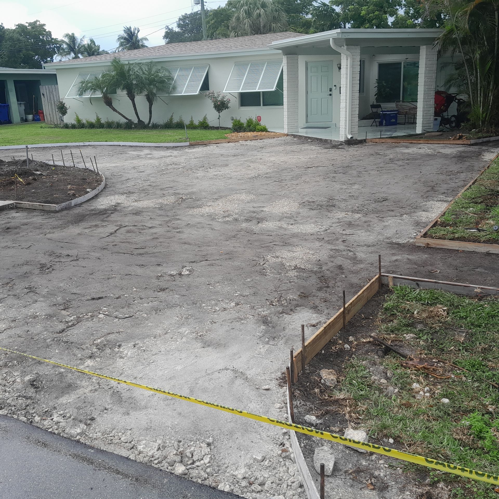Driveway under construction with a house in the background in Parkland FL