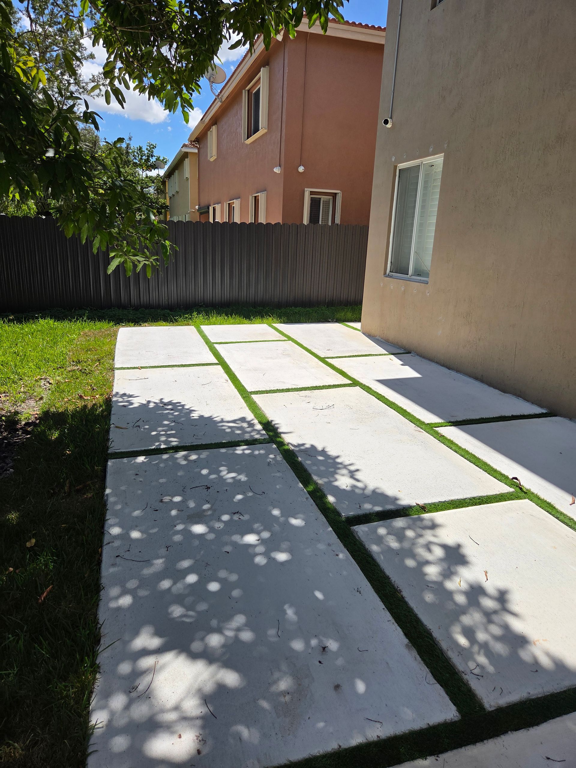 Concrete pavers with green grass strips in Parkland FL