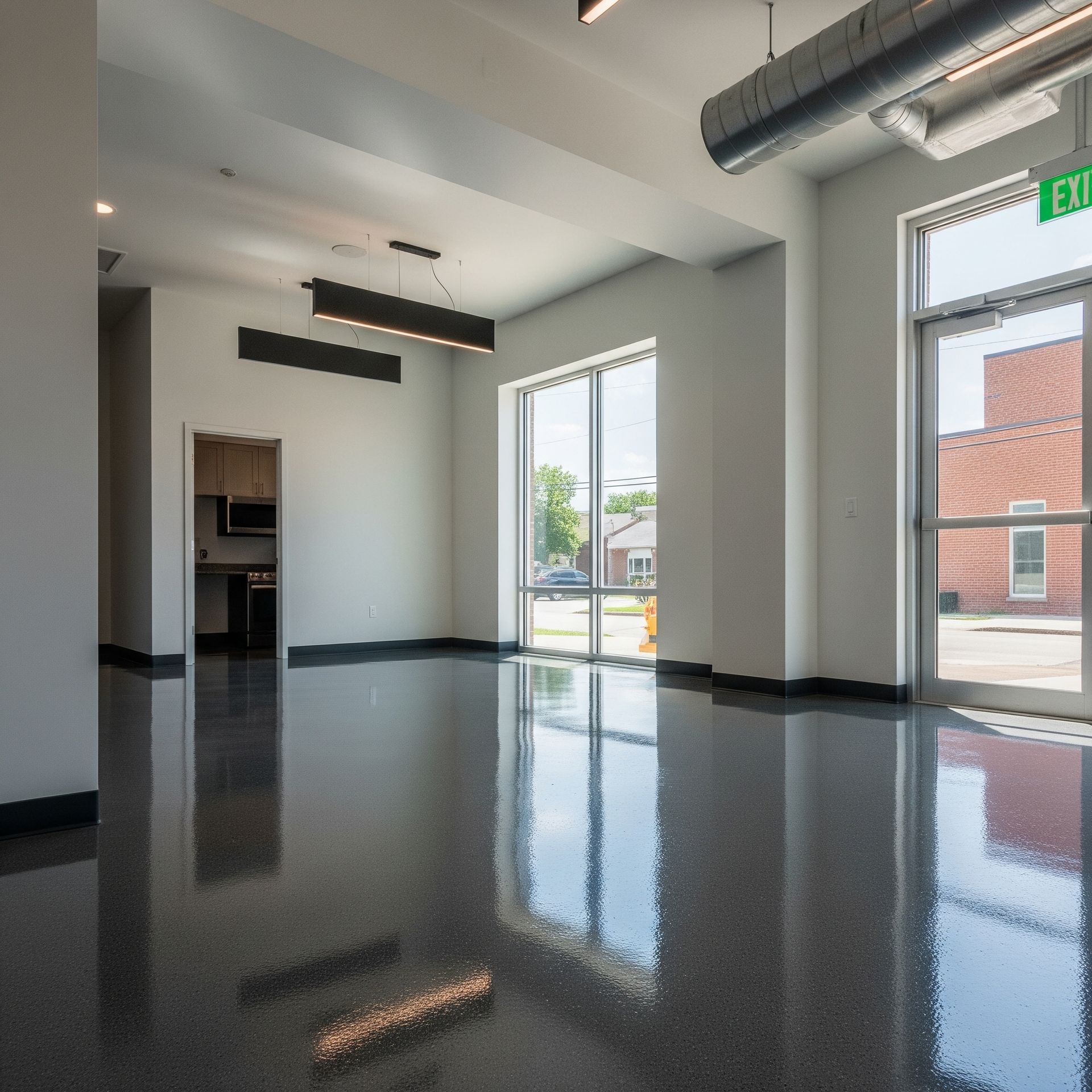A large empty room with a brick building in the background