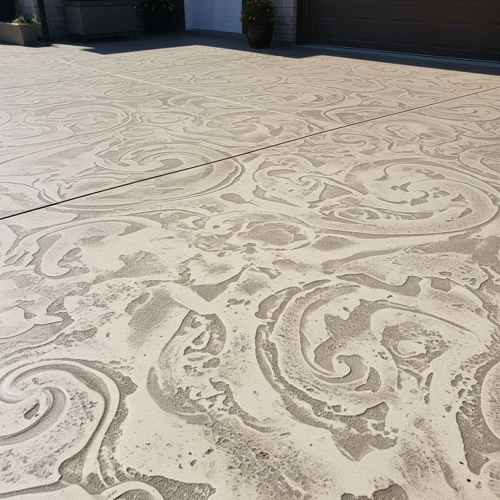 A concrete driveway with a swirl pattern on it