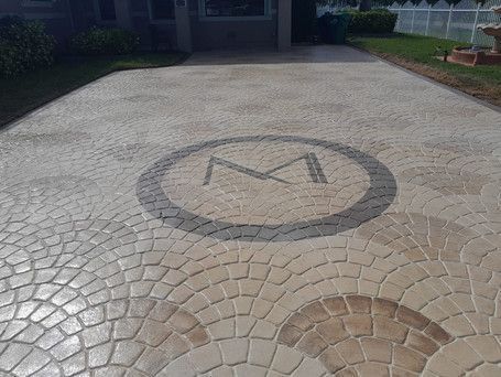 A driveway with a monogram in the middle of it.
