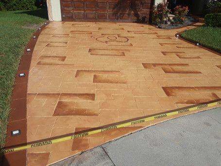 A concrete driveway with a stenciled design on it