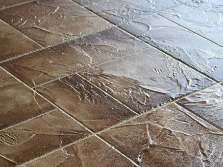 A close up of a tiled floor with a white border