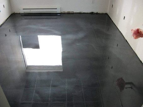 A room with a black tile floor and a window