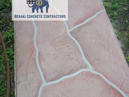 A concrete walkway with a logo for beraki concrete contractors