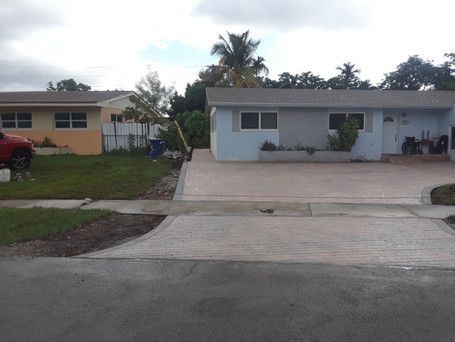 A red truck is parked in front of a house