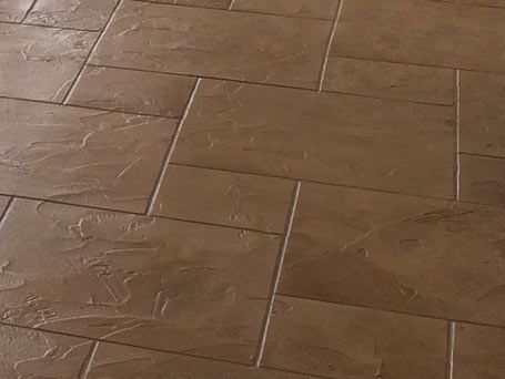 A close up of a brown tile floor