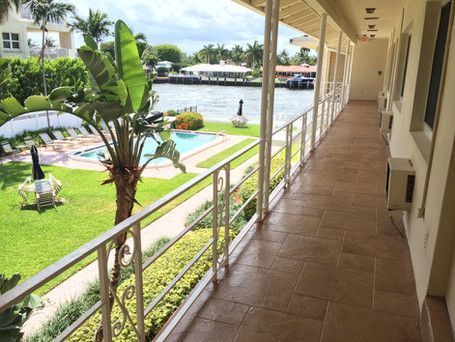 A long hallway with a view of a swimming pool