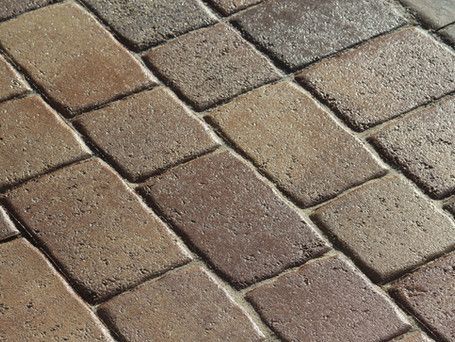 A close up of a brick floor with a diagonal pattern