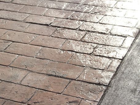 A close up of a brick walkway with the sun shining on it