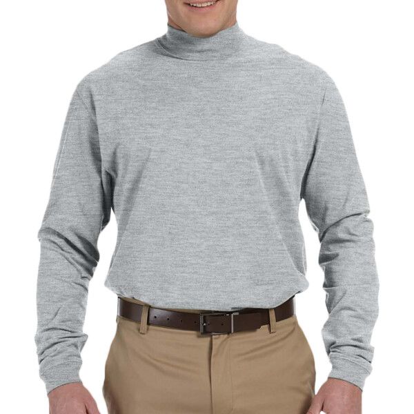 A man wearing a grey turtleneck and khaki pants