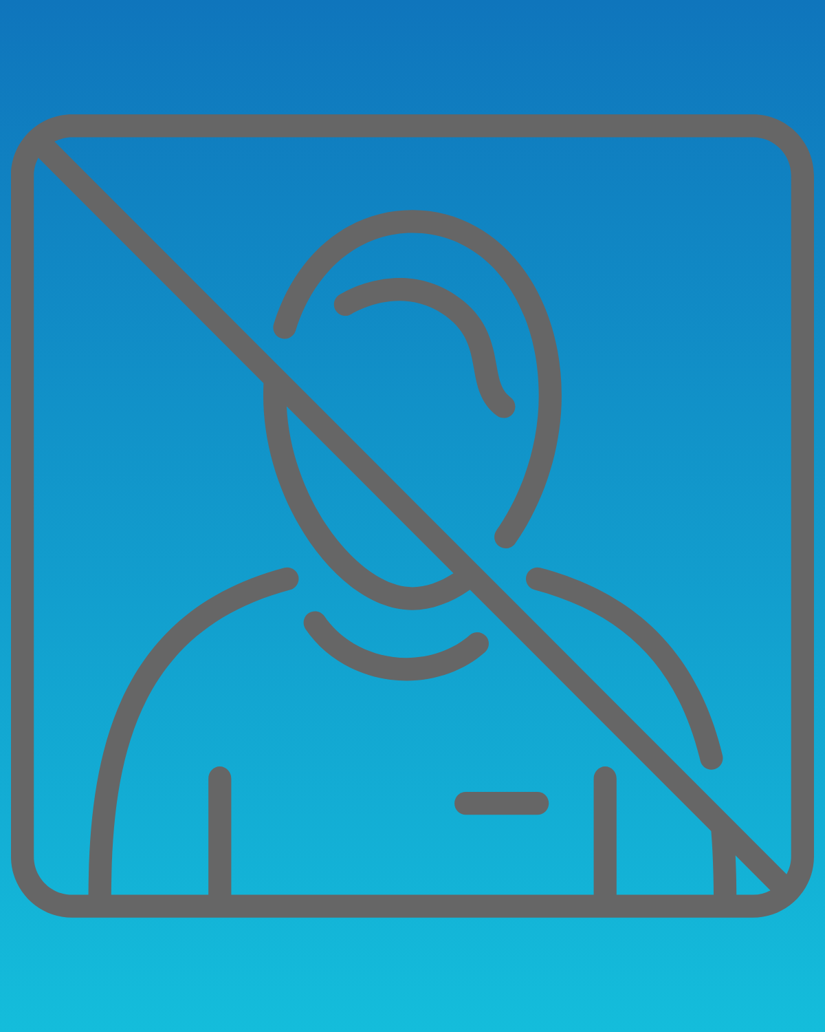 A man in a plaid shirt is smiling in front of a blue background.