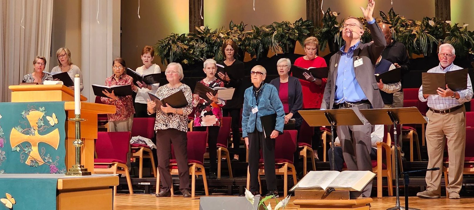 A group of people are singing in a church choir.