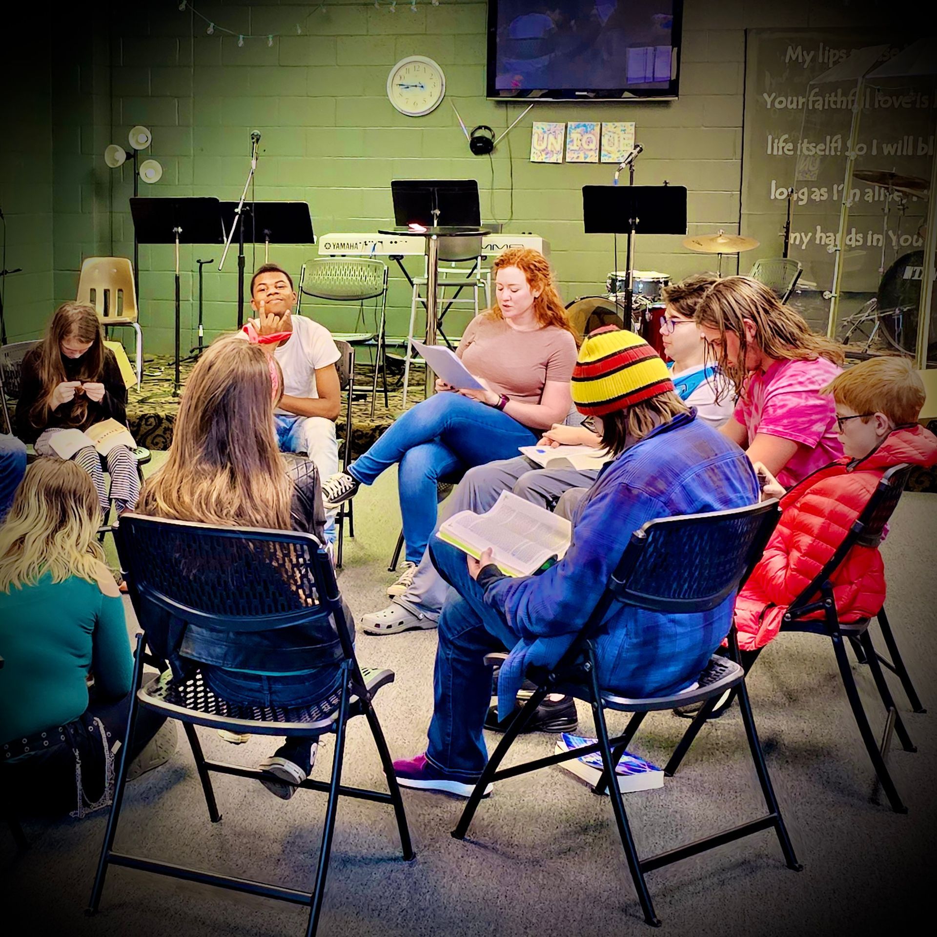 A group of people are sitting in a circle reading books
