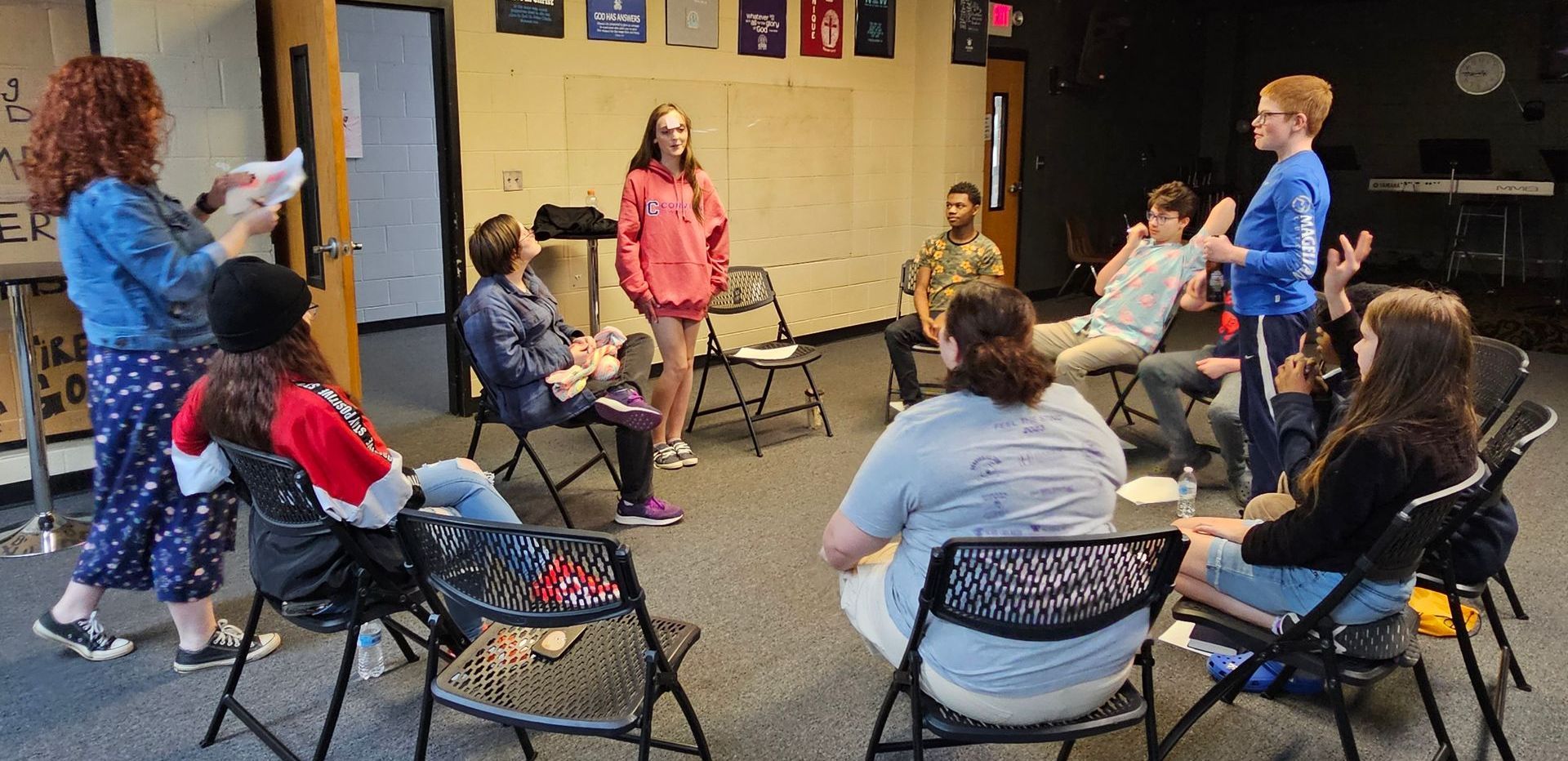 A group of people are sitting in a circle in a room.