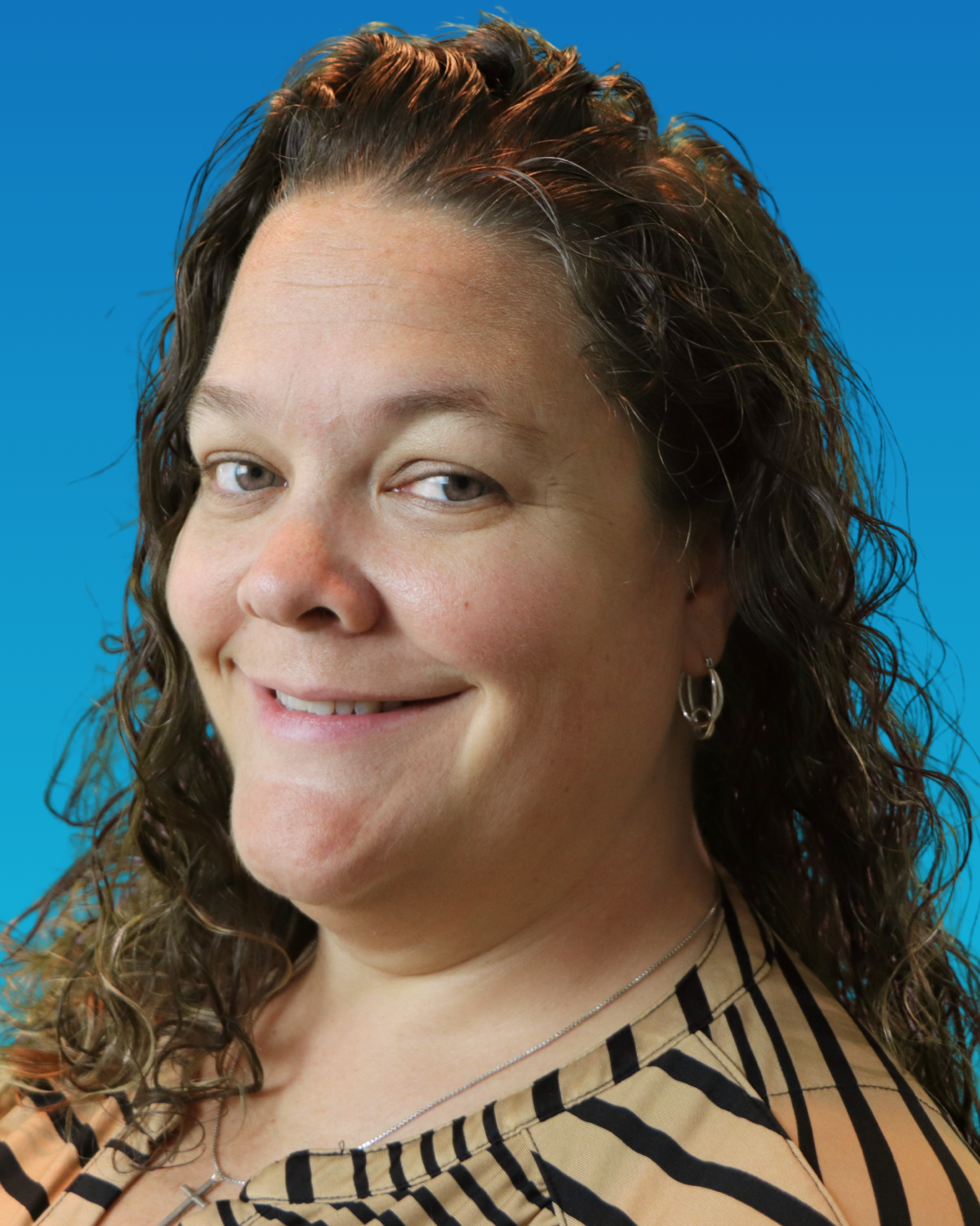 A woman with green hair is smiling for the camera