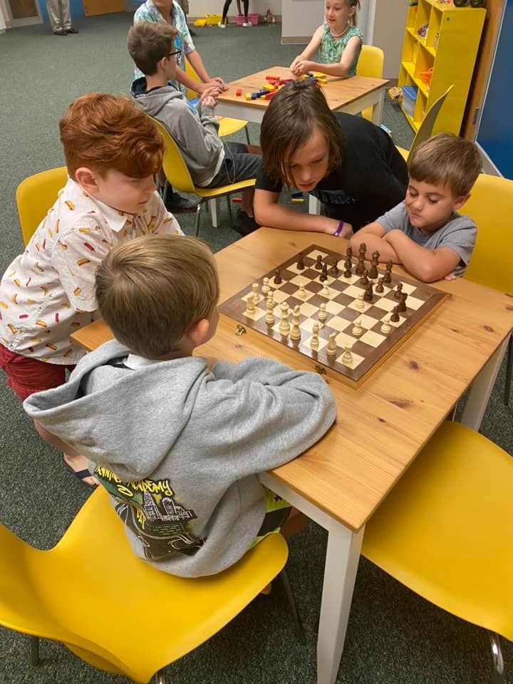 A group of children are playing a game of chess