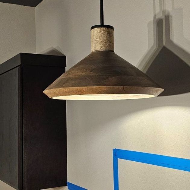 A wooden lamp hanging from the ceiling in a room