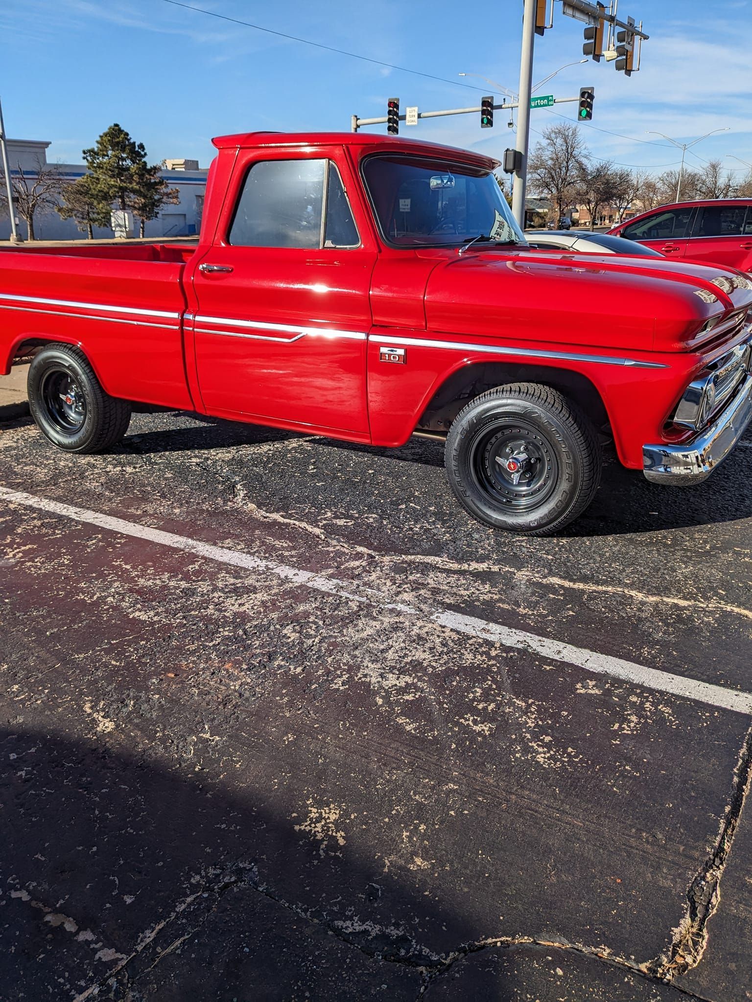 A red truck is parked on the side of the road.