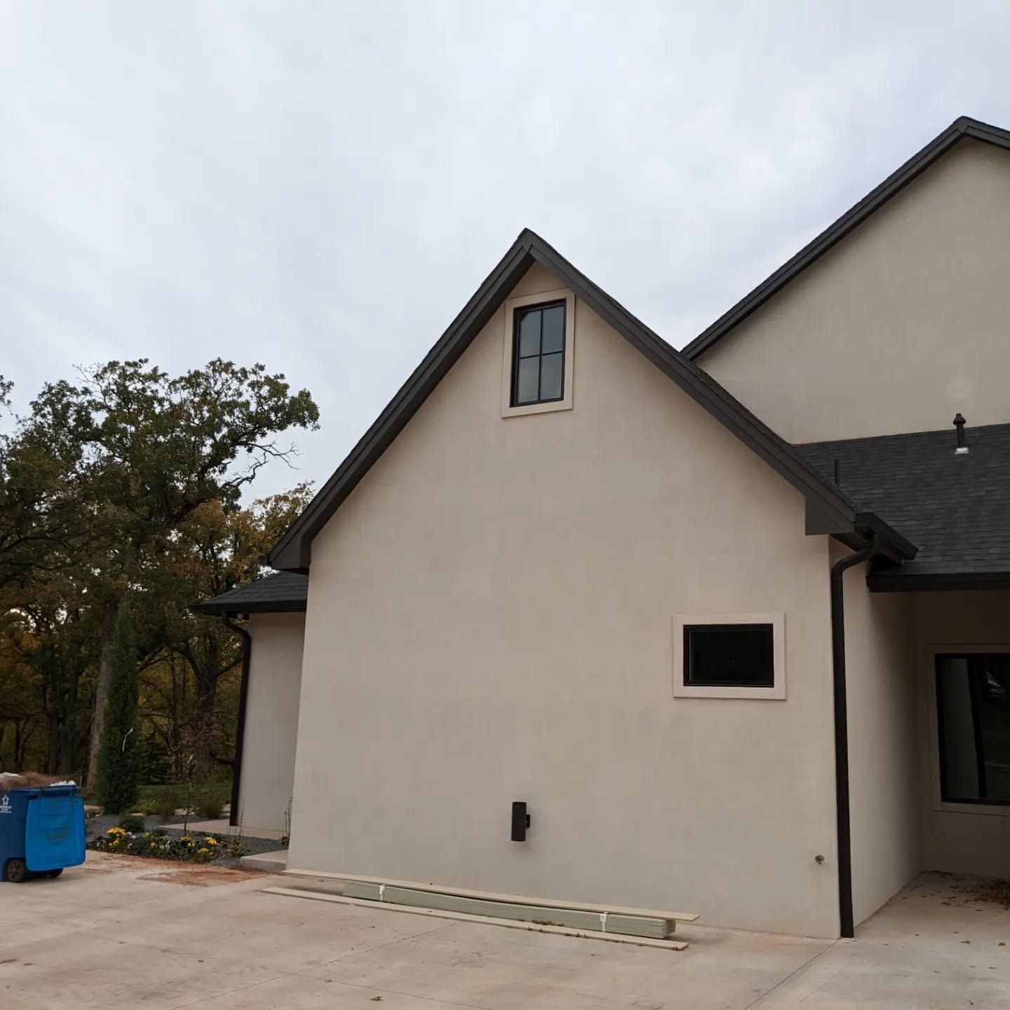 A white house with a black roof and a window