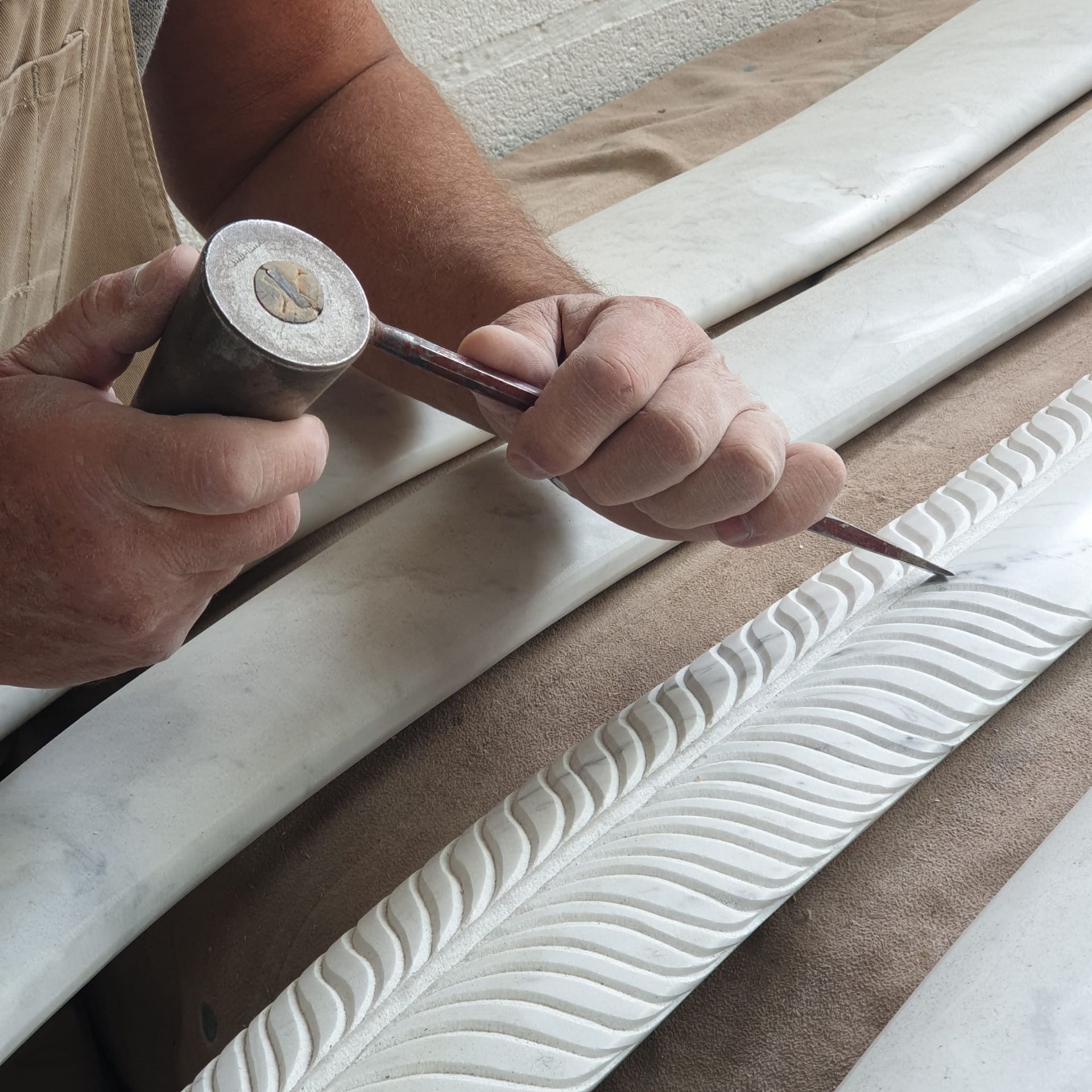 A person is carving a pattern on a piece of wood