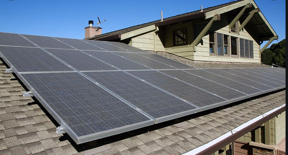 A house with a lot of solar panels on the roof