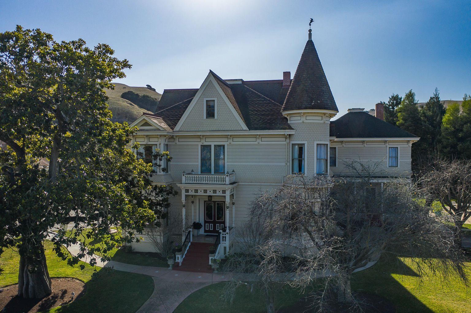 An aerial view of a large house with a tower on top of it