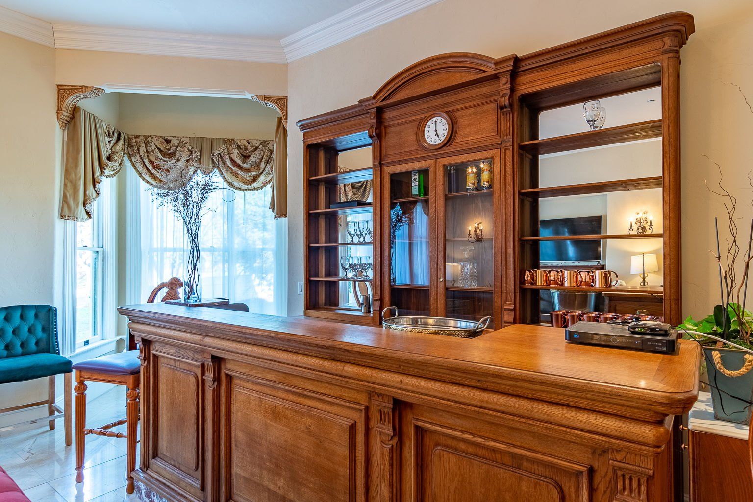 Guest amenities at Chateau Coralini including reusable glass water carafe, Keurig coffee, and elegant Victorian details.