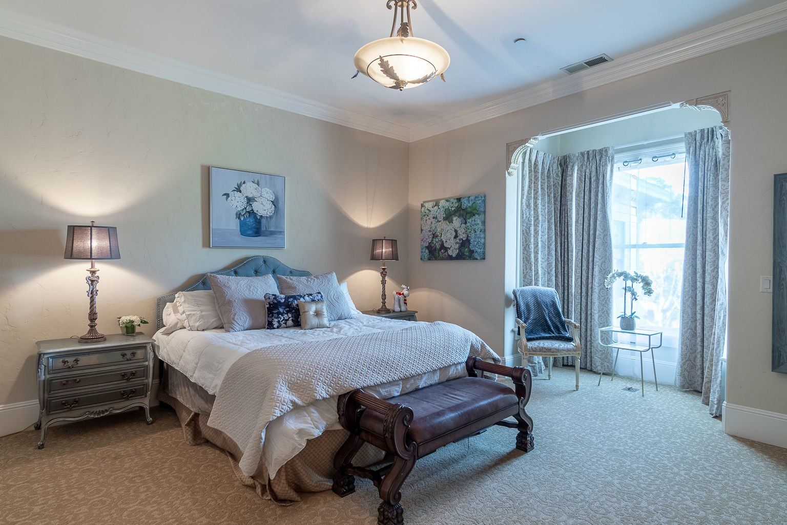 Chateau Coralini guest suite with Victorian furnishings and cozy bedding near Monterey.