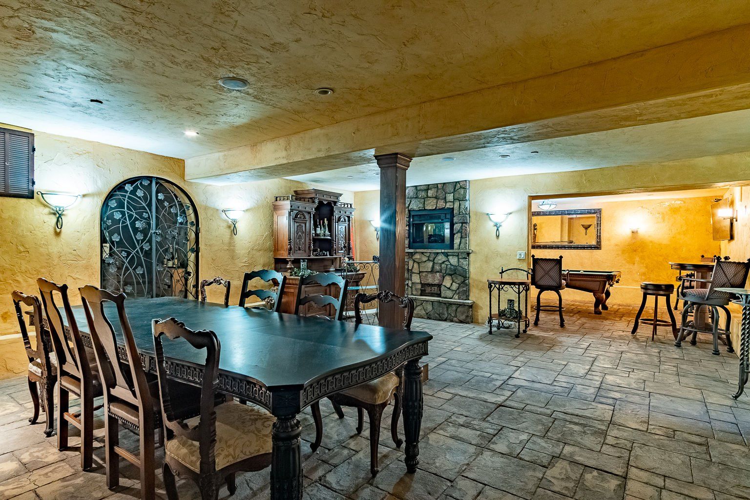 There is a table and chairs in the middle of the room.