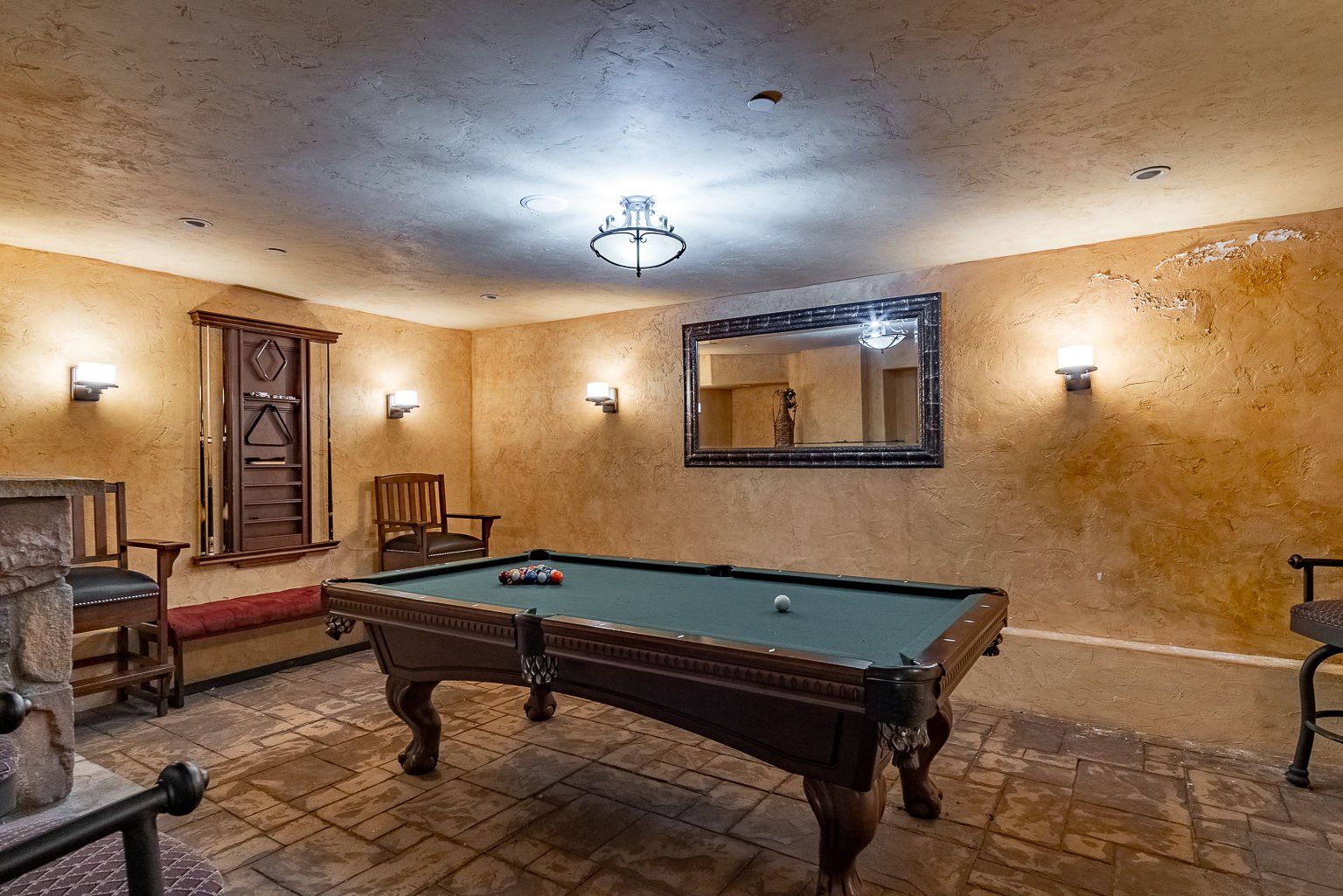 There is a pool table in the middle of the room.