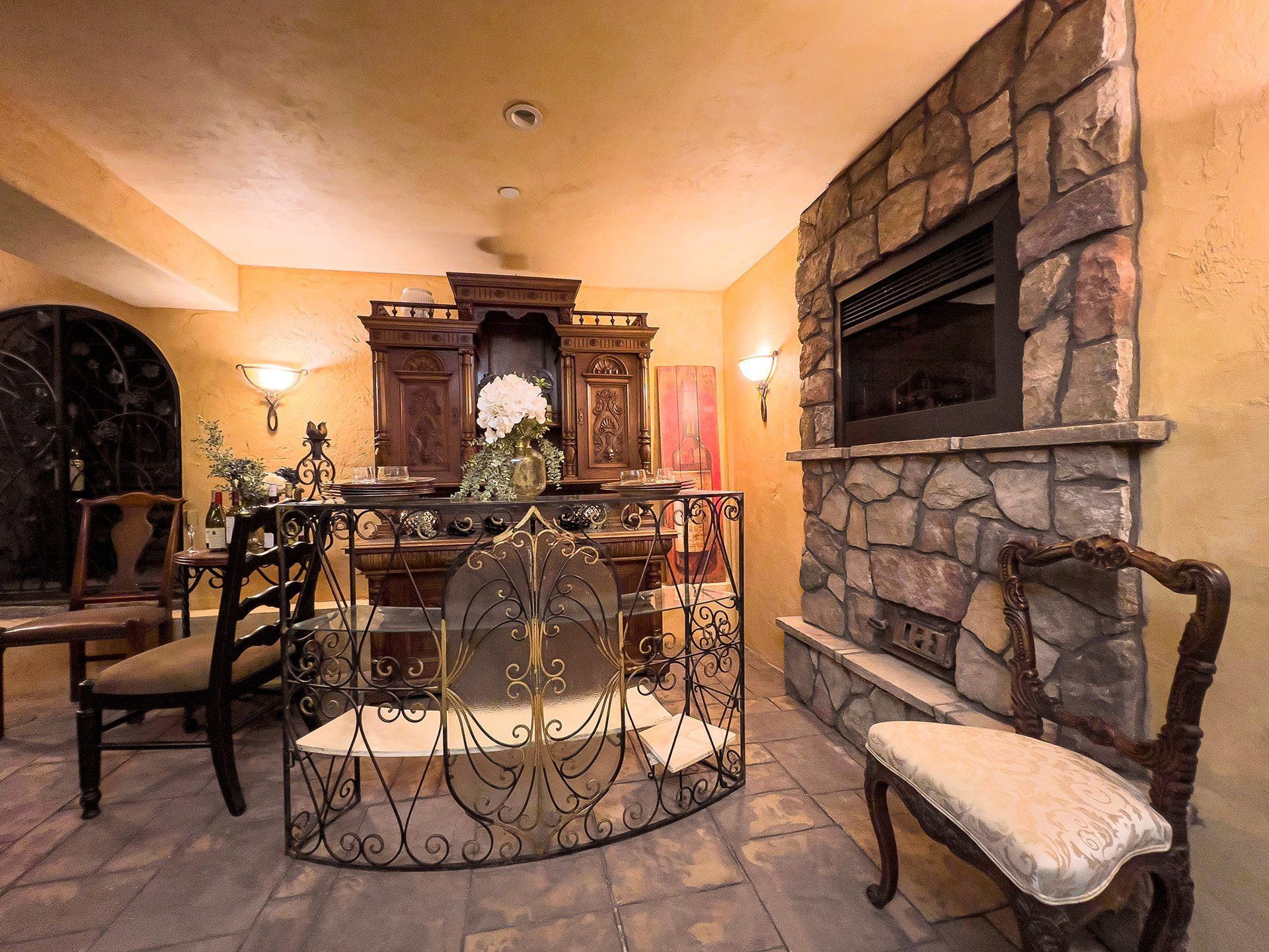 A living room with a fireplace and chairs
